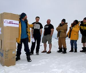 Expeditioners lining up to vote in a make shift cardboard voting boot