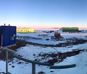 A photo taken from the front door of the water services building showing the station with the sea ice and ice bergs in the distance