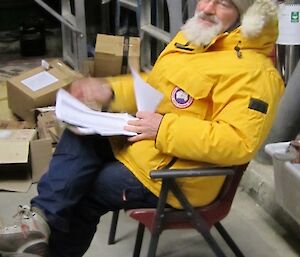 Expeditioner sitting on his chair going through the paperwork