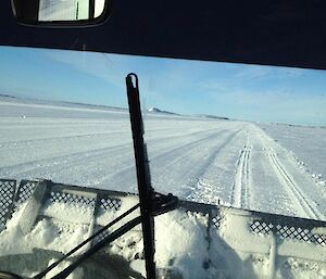 A photo taken from inside the Prinoth snow groomer looking down the length of the ski landing area