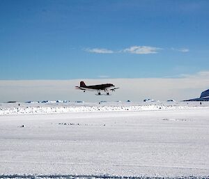 The Basler aircraft does a second low pass to check out the landing surface