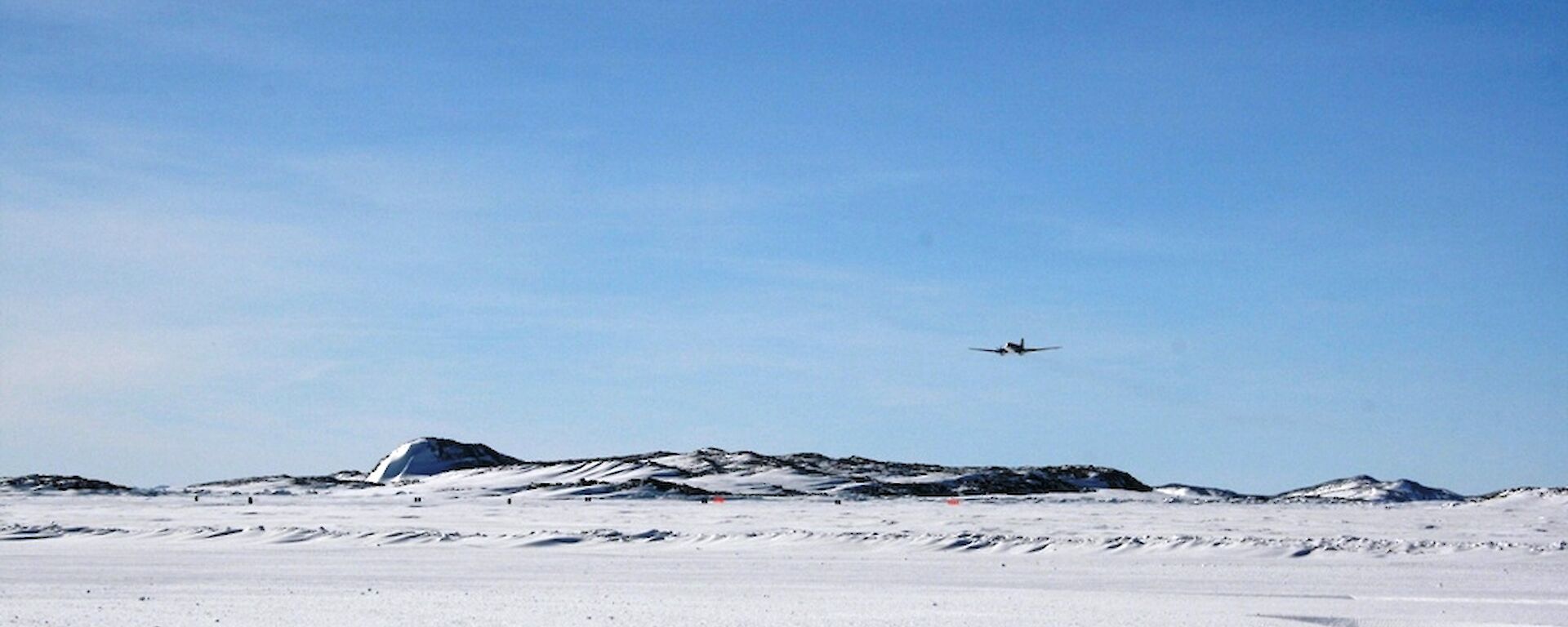 The Basler aircraft flying towards the runway to have a look at the landing surface