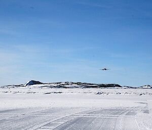 The Basler aircraft flying towards the runway to have a look at the landing surface