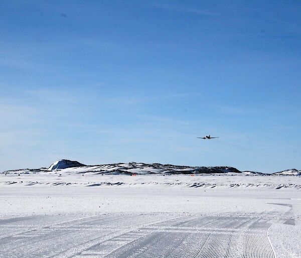 The Basler aircraft flying towards the runway to have a look at the landing surface