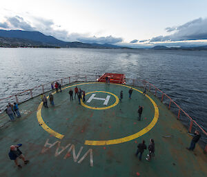 Expeditioners standing on deck as the ship departs Hobart