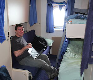 An expeditioner in his cabin on the ship