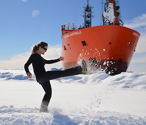 An expeditioner kicking snow in the direction of the ship.