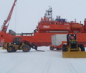 A number of heavy vehicles on the ice near the ship
