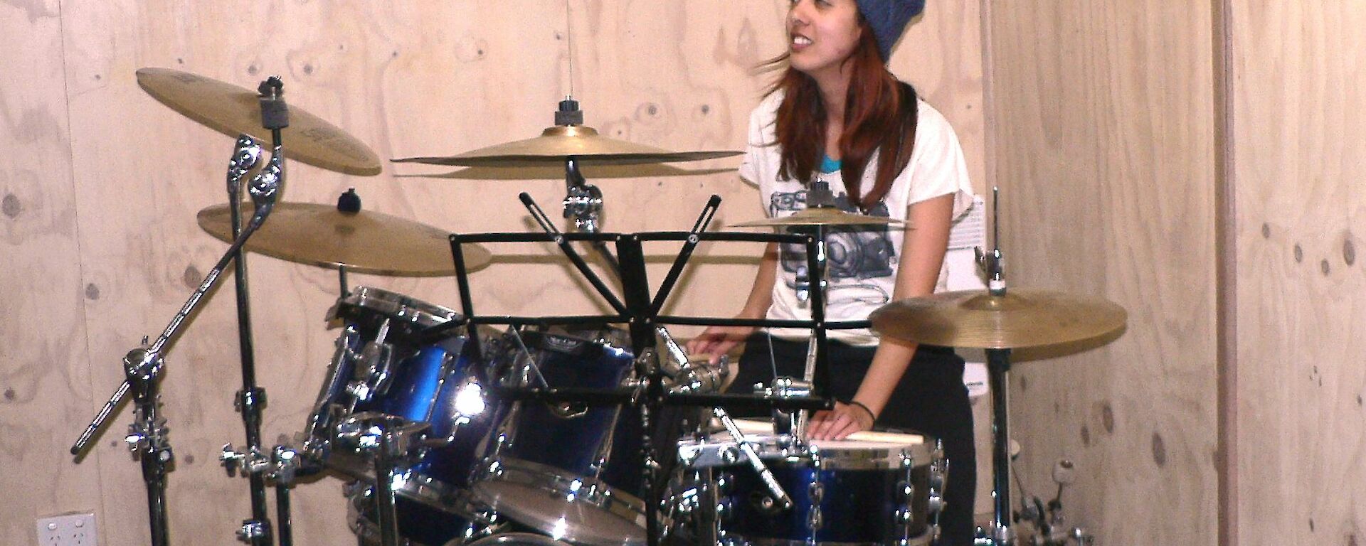 A female expeditioner playing drums