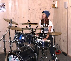 A female expeditioner playing drums