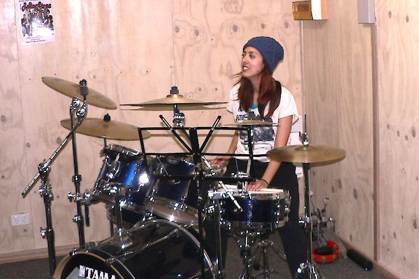 A female expeditioner playing drums