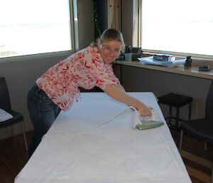 An expeditioner ironing the table cloths