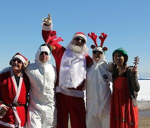 Five expeditioners dressed as Santa & his helpers