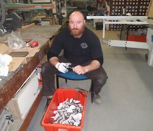 An expeditioner painting the mushroom bolts