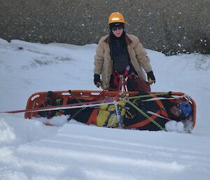 A patient in a stretcher being pulled up a cliff