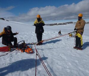 A group of expeditioners being shown how to tie ropes