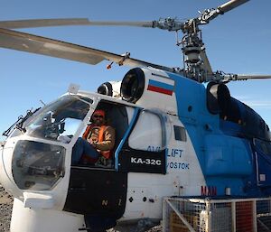 Expeditioner sitting in cockpit of helicopter