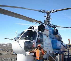 An expeditioner standing beside a Russian helicopter at Davis