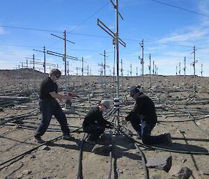 Workman laying poly pipe line near masts