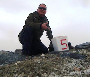 An expeditioner next to a 5 kilometer marker during the KBA challenge