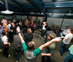 Expeditioners dancing to the music from the band