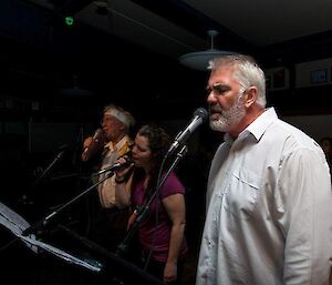 Three singers in front of the band