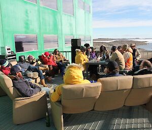 Group of expeditioners sitting on the balcony at Davis