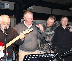 Four Russian expeditioners singing a song