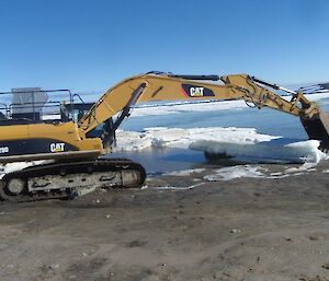 Excavator moving sea ice from the Davis Beach