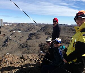 Four expeditioners on field training on top of a hill