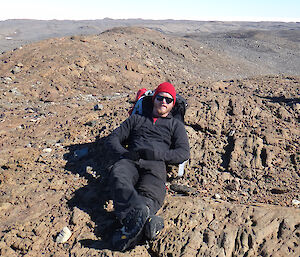 An expeditioner resting on his back pack