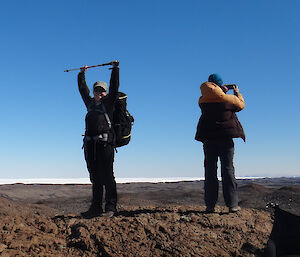 Two expeditioners on top of a hill