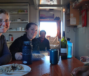 Expeditioners having dinner in a field hut