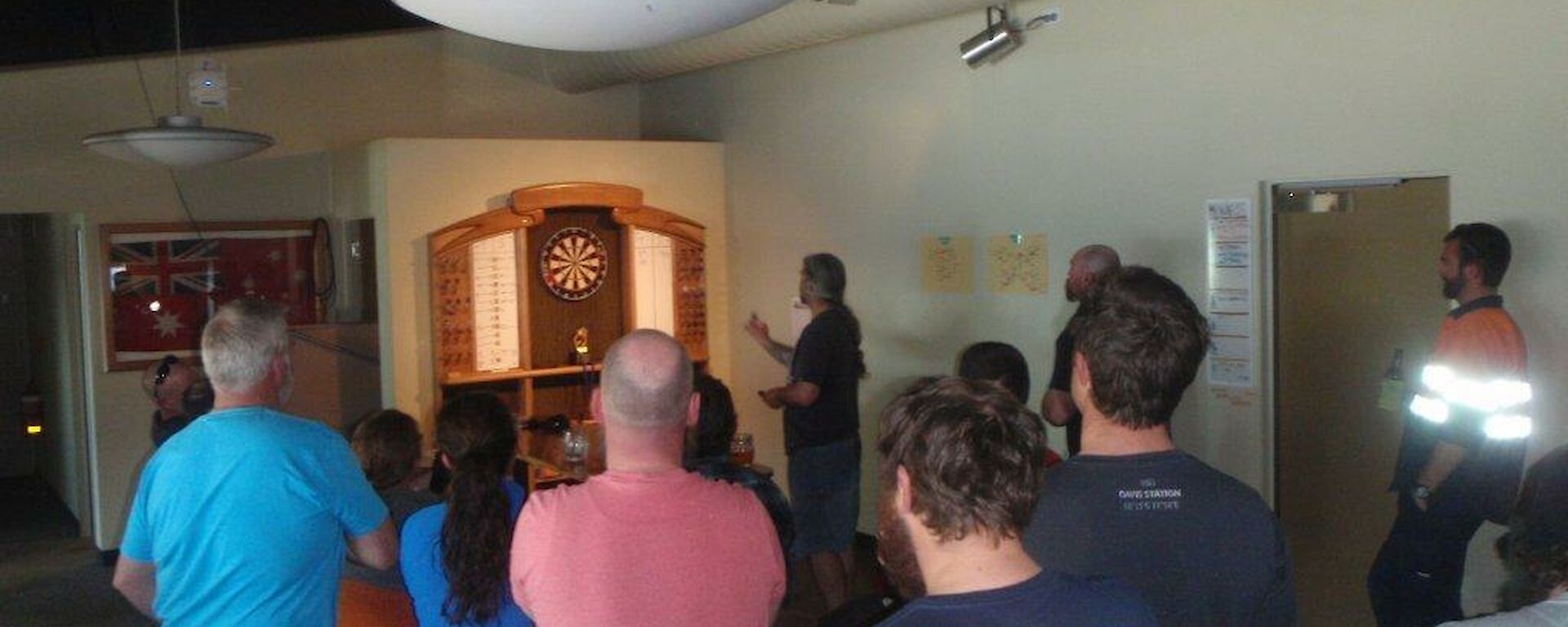 Group of expeditioners watching a dart game