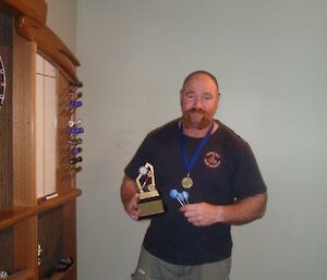 A expeditioner holding a trophy