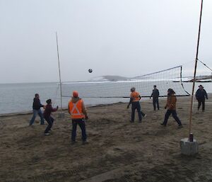 A game of volleyball being played on the Davis Beach