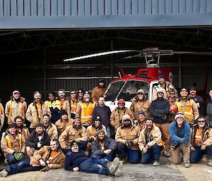 Group of expeditioners in front of a new building they built over the summer