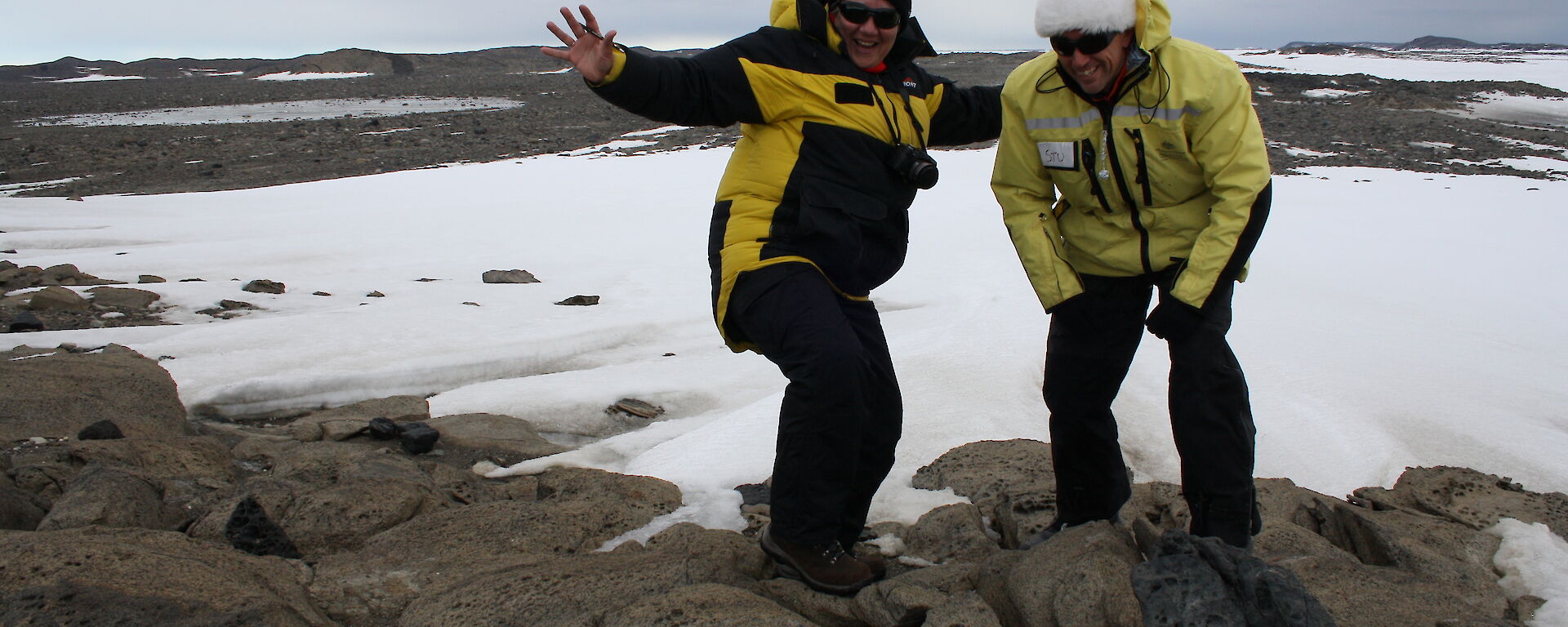 Two expeditioners in the field working with automatic camera installations