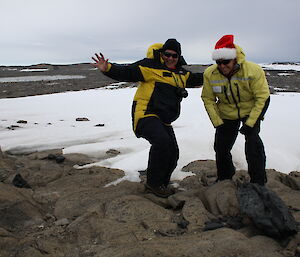 Two expeditioners in the field working with automatic camera installations