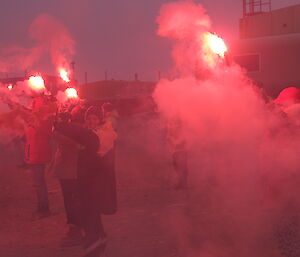 expeditioners holding flares