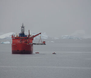 unloading a barge from the aurora australis over the side of the ship