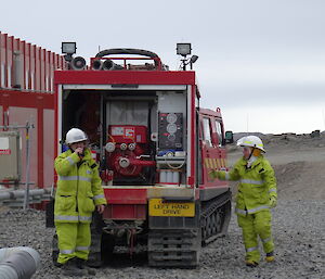 2 expeditioners dressed in fire turn out gear alongside the fire hagg