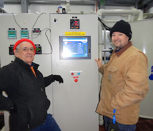 2 expeditioners demonstrating how to operate the RO plant
