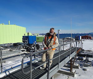 expeditioner on a steel frame foot bridge