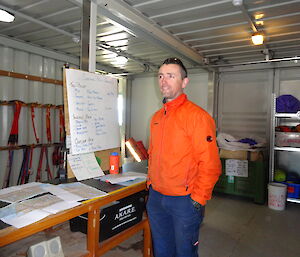 expeditioner standing next to white board