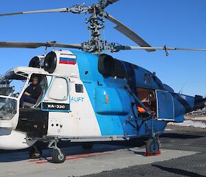 australian expeditioner sitting in the front seat of the large helicopter