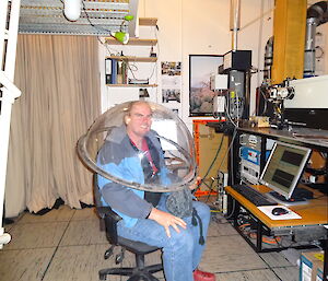 Expeditioner in the science building with a large dome on his head