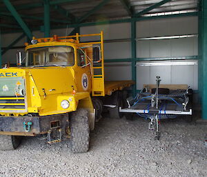 large mack truck and trailer inside shed