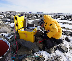 Expeditioner installing solar panel in the field for science