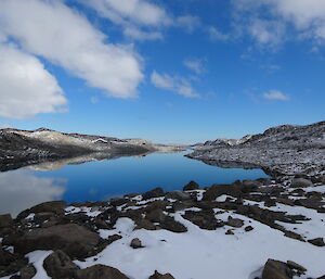 lake showing mirror image of cliffs, sky and clouds